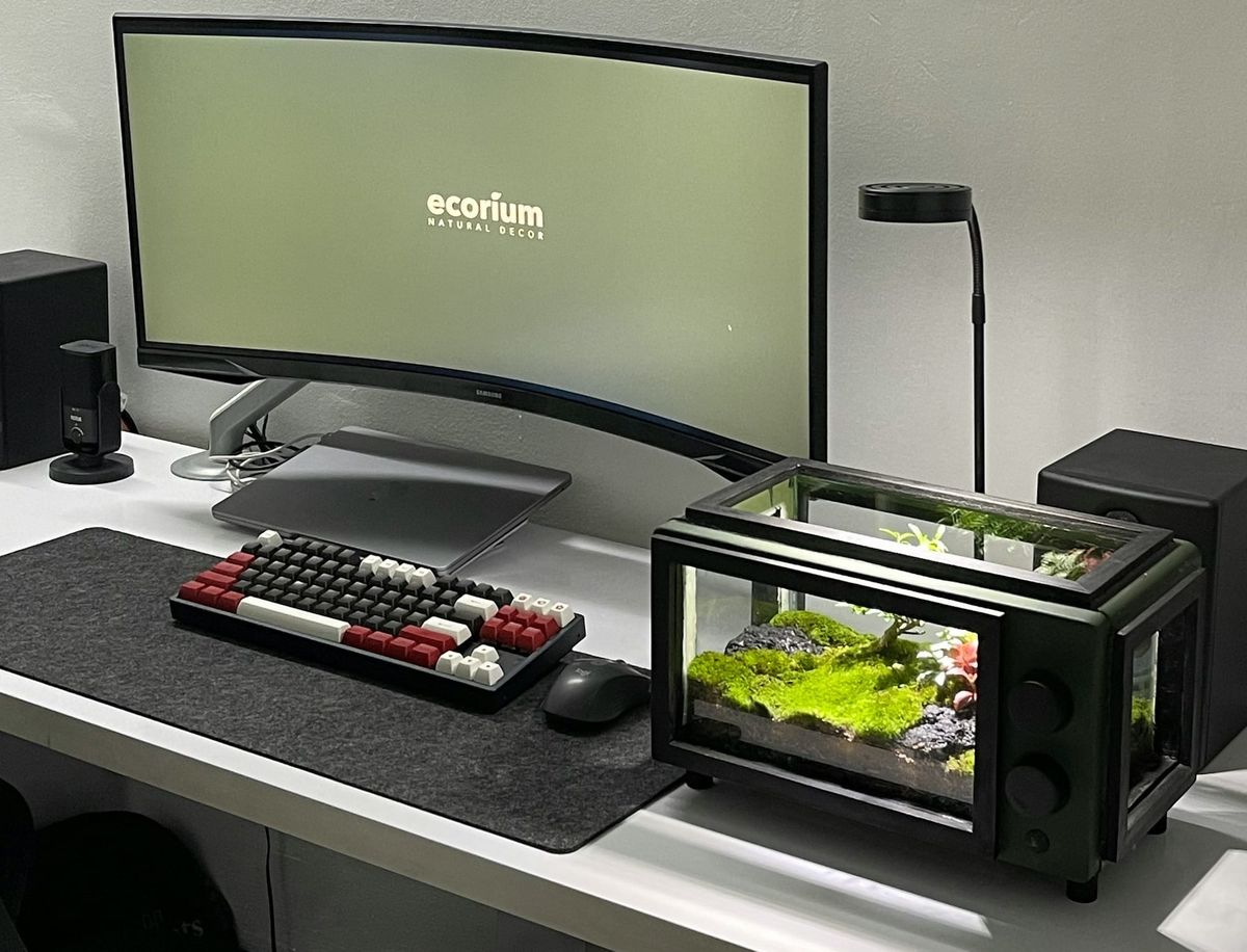 A mechanical timer sitting next to modern computing monitors
